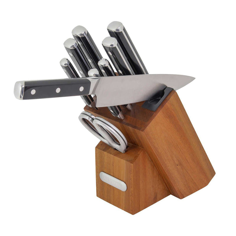 Set of knives in a wooden block on a white background