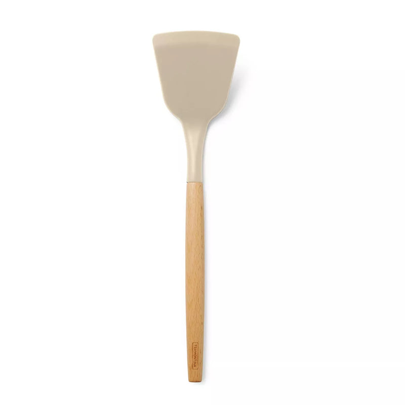 Spatula with beige silicone head and wooden handle on a white background