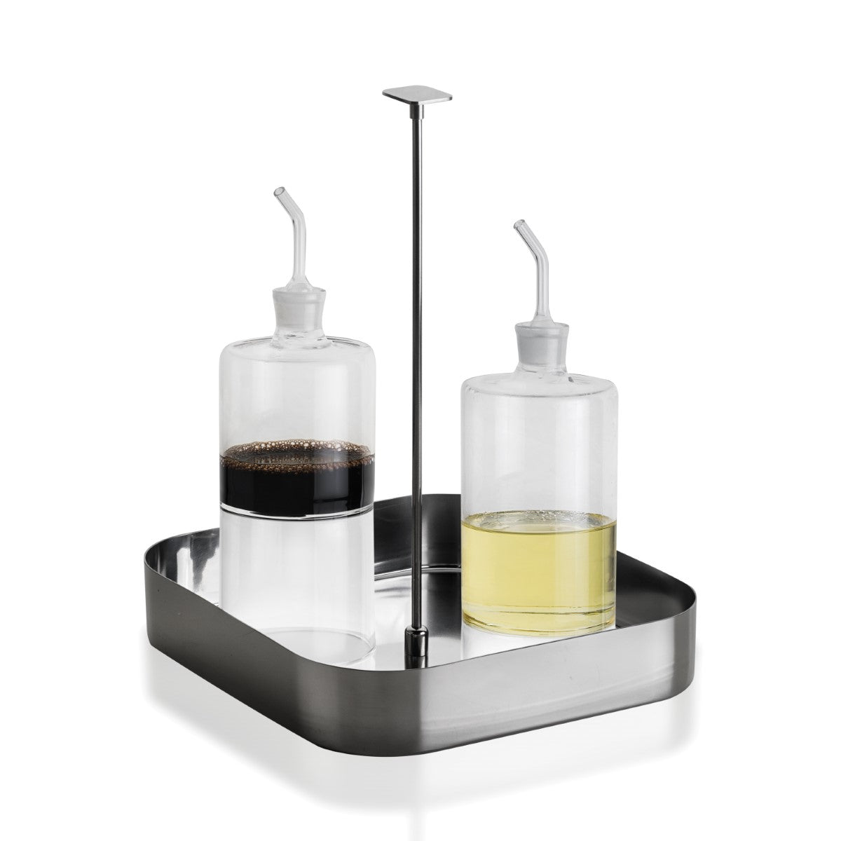 Two glass bottles with liquid on a black tray against a white background