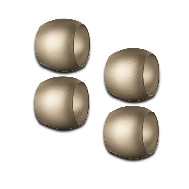 Four gold Mepra napkin rings on a white background
