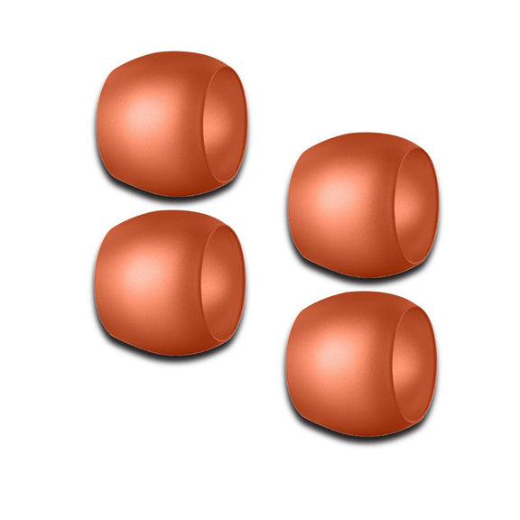 Four copper-colored Mepra napkin rings on a white background