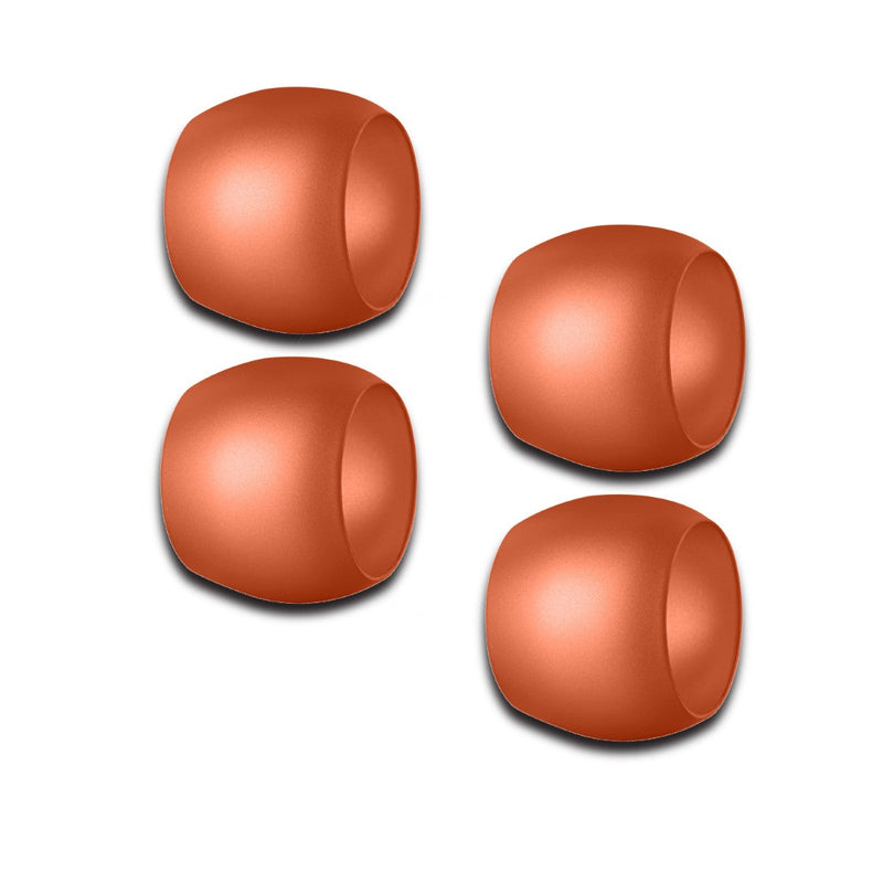 Four copper-colored Mepra napkin rings on a white background