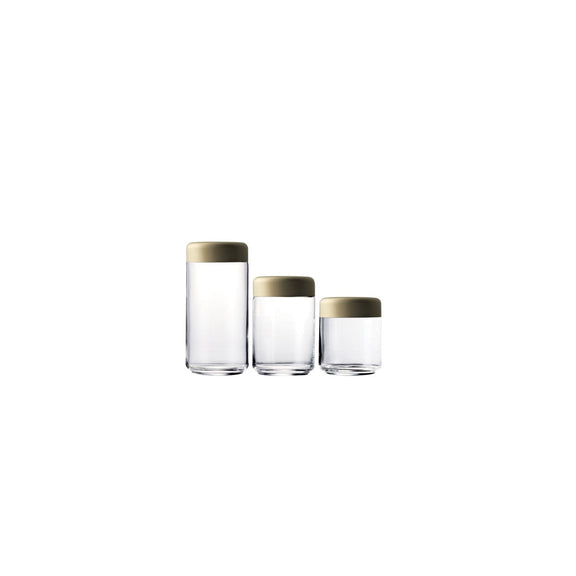 Three glass containers with gold lids on a white background