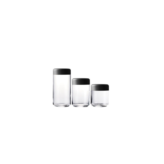 Three glass containers with black lids on a white background