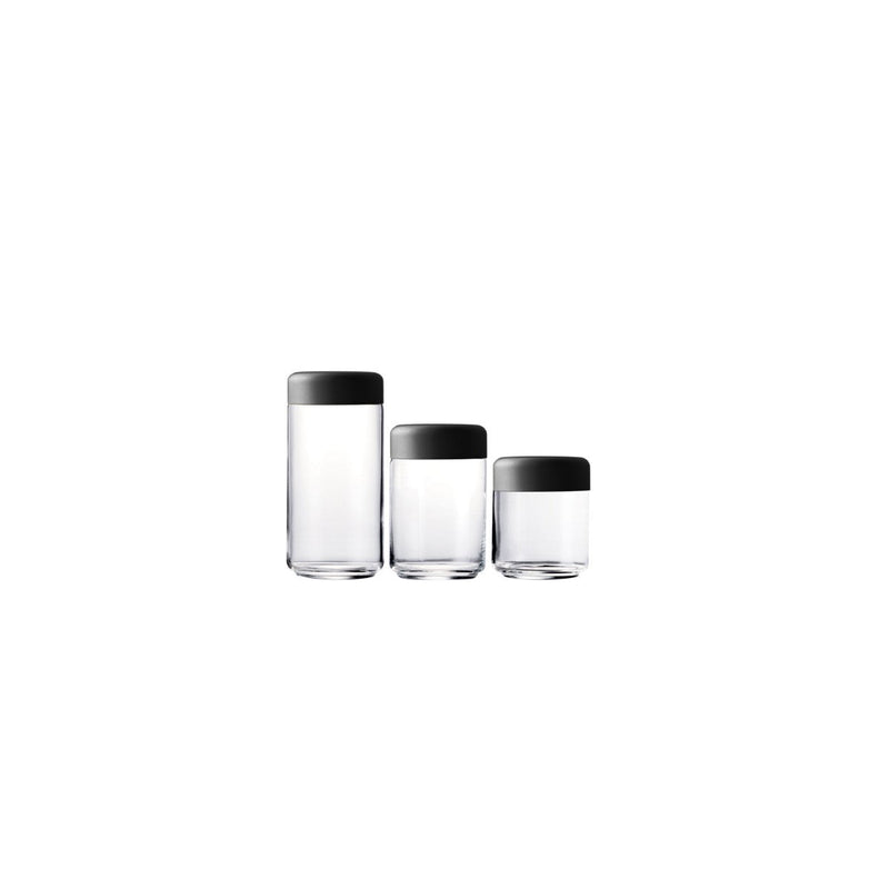 Three glass containers with black lids on a white background
