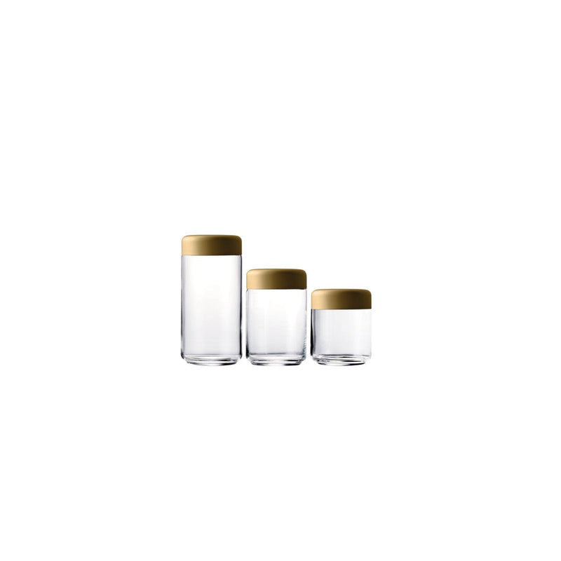 Set of three glass containers with gold lids on a white background