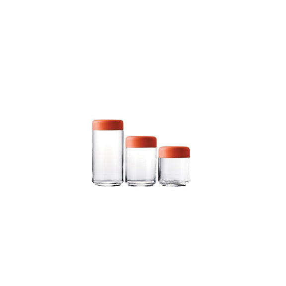 Set of three glass containers with orange lids on a white background