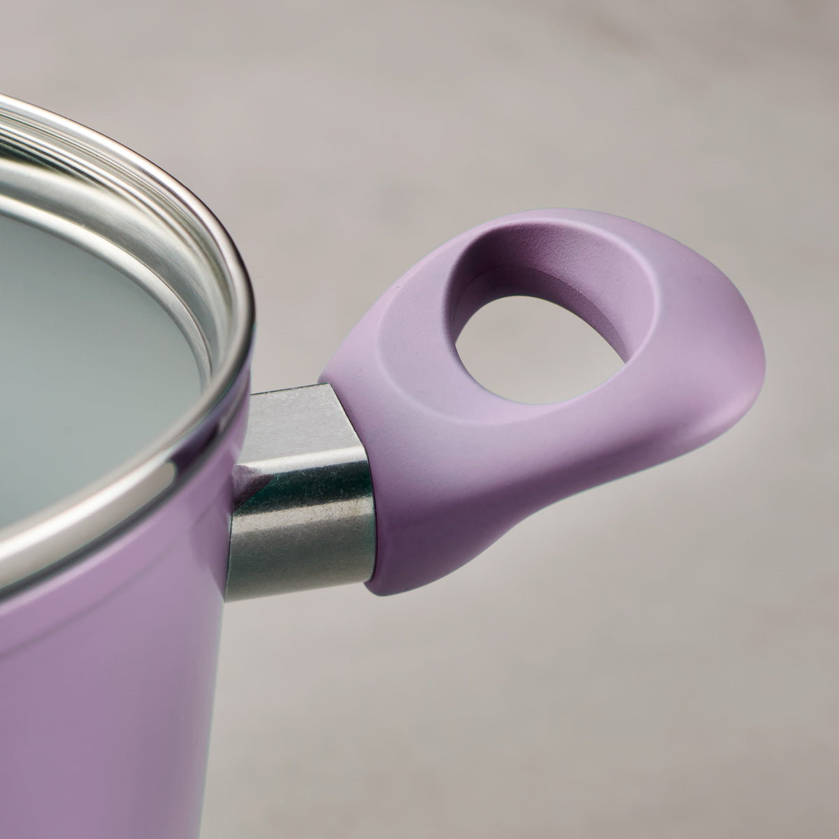 Close-up of a purple pot handle on a gray background