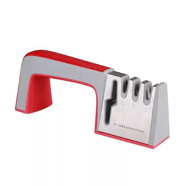 Knife sharpener with red handle and silver metal parts on a white background
