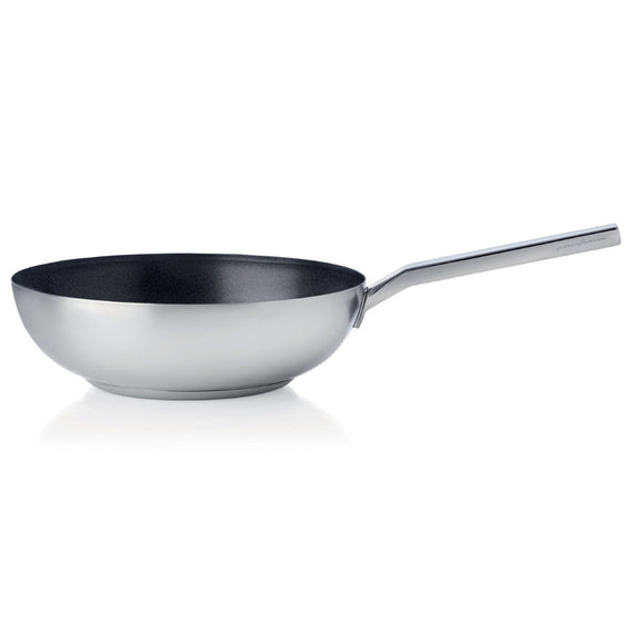 Stainless steel wok with a black interior on a white background