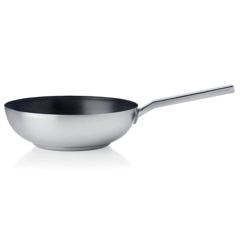 Stainless steel wok with a black interior on a white background