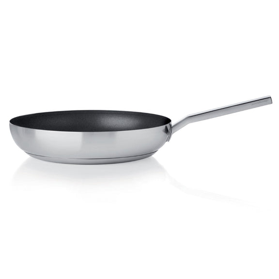 Stainless steel frying pan with a black non-stick surface on a white background