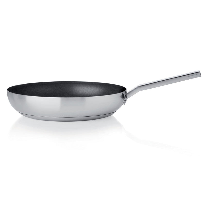Stainless steel frying pan with a black non-stick surface on a white background