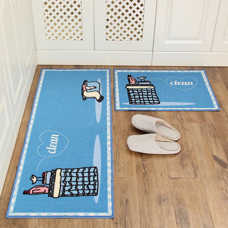 Two blue doormats with cartoon designs on a wooden floor, one labeled 'clean'.