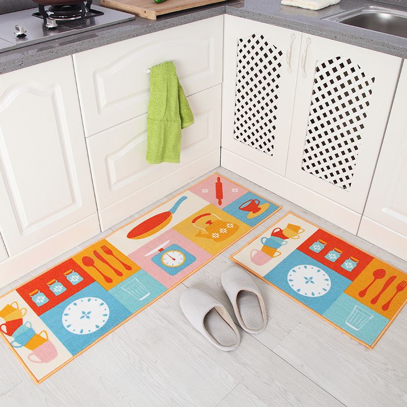 Colorful kitchen-themed mats on a floor with white shoes nearby in a kitchen setting.