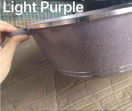 Light purple speckled pot held by a hand on a tiled floor.