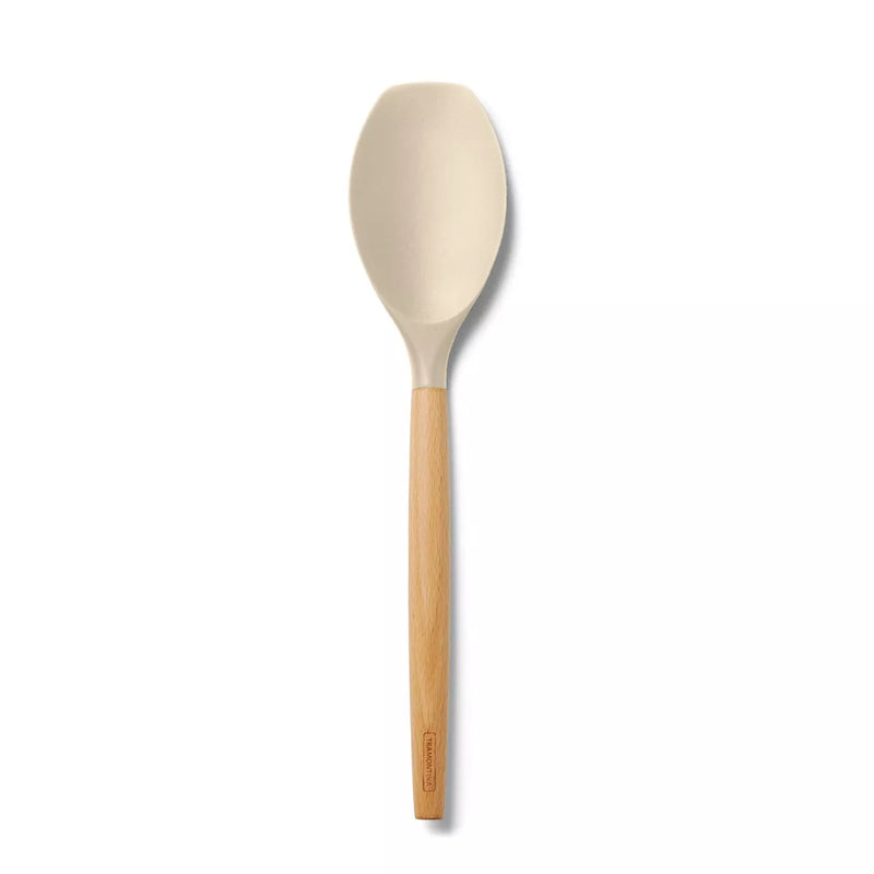 Beige spoon with wooden handle on a white background