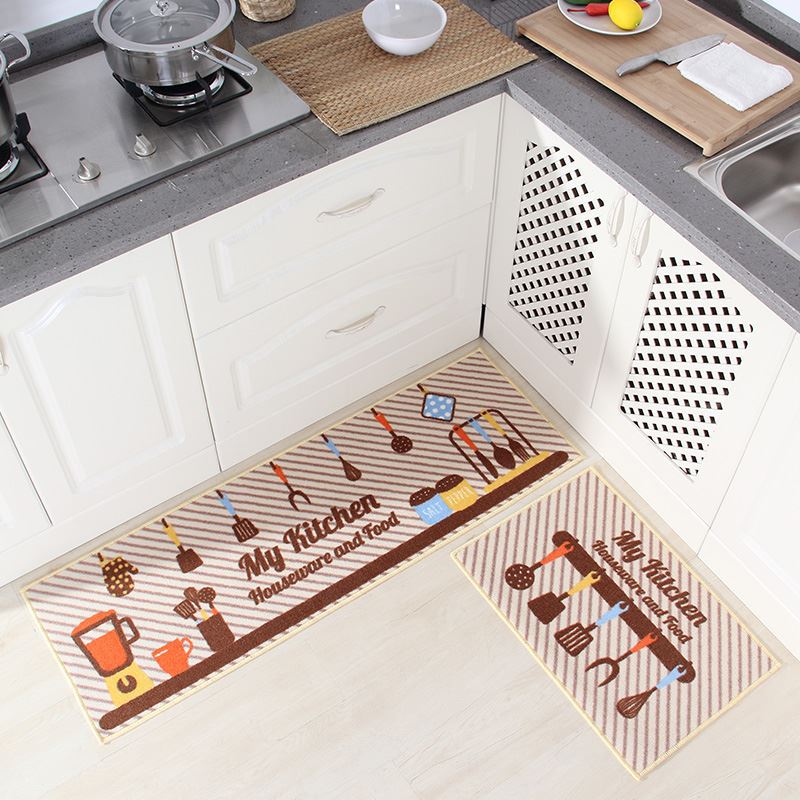 Two kitchen mats with decorative patterns on a kitchen floor.
