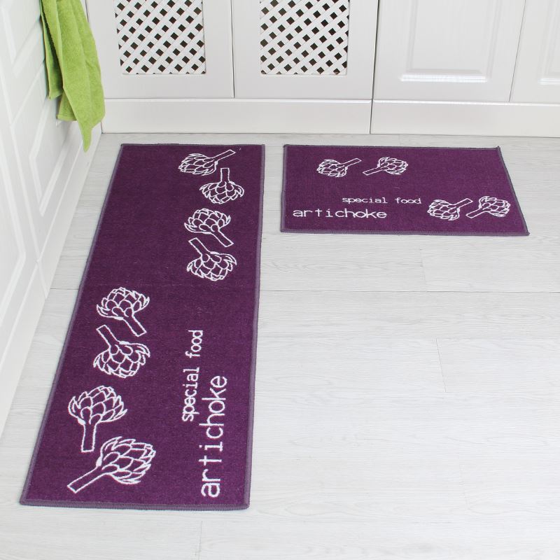 Purple bath mats with artichoke design on a white floor.