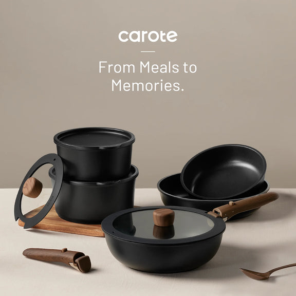 Black cookware set with wooden handles on a beige surface, featuring the brand 'carote'.