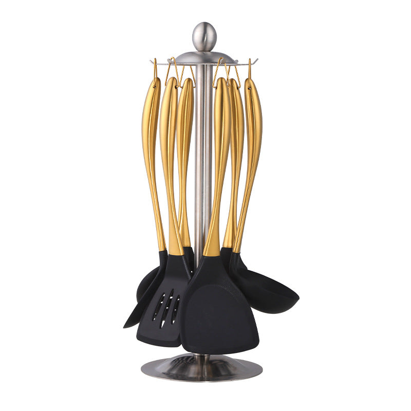 Set of black and gold kitchen utensils on a white background