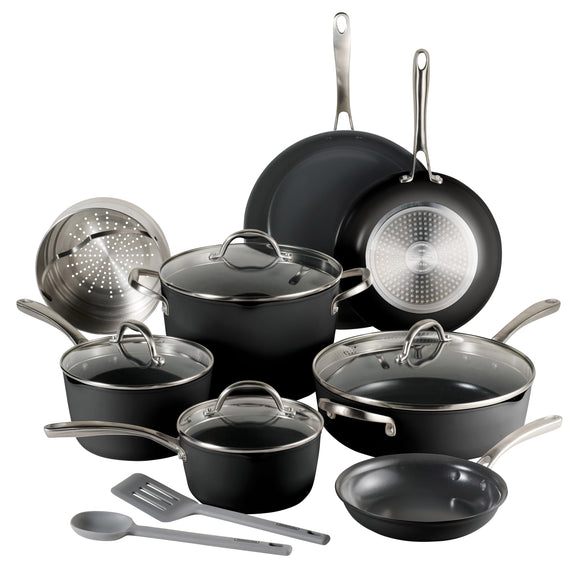 Set of black cookware with glass lids and silver handles on a white background