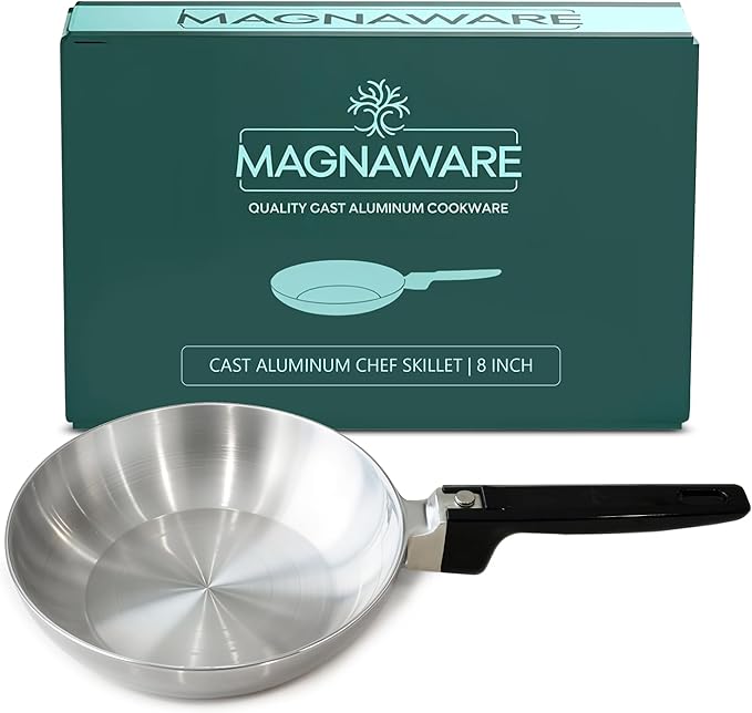 Cast aluminum chef skillet with black handle in front of Magnaware packaging.