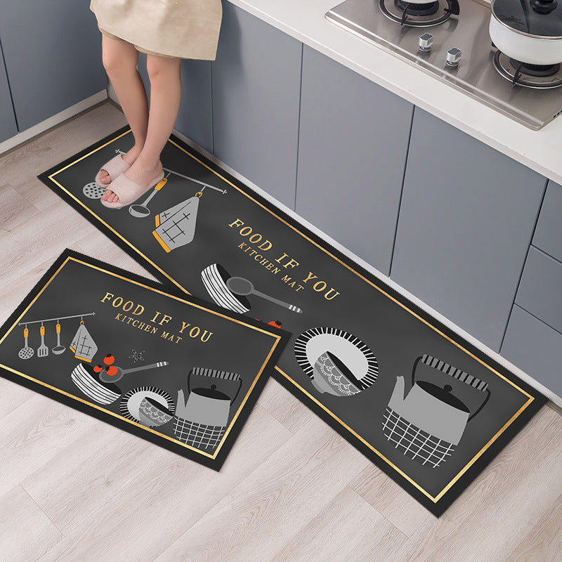 Two kitchen mats with cooking utensil designs on a wooden floor.