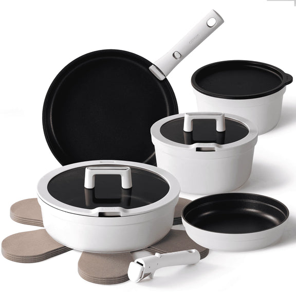 Set of cookware including pots, pans, and lids on a white background