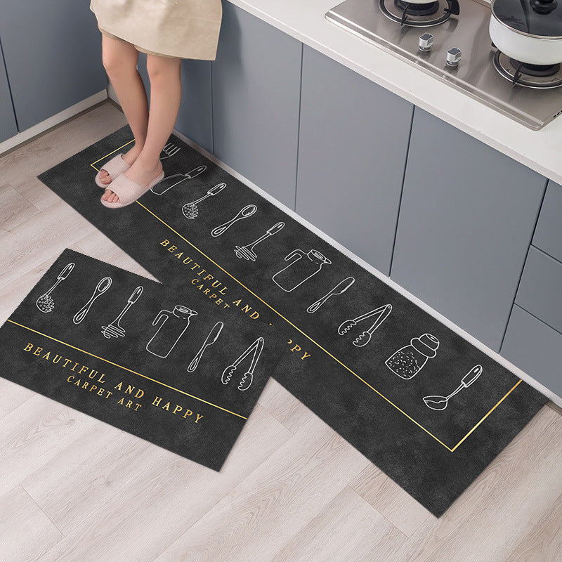 Two black kitchen mats with white illustrations on a wooden floor in a kitchen setting.