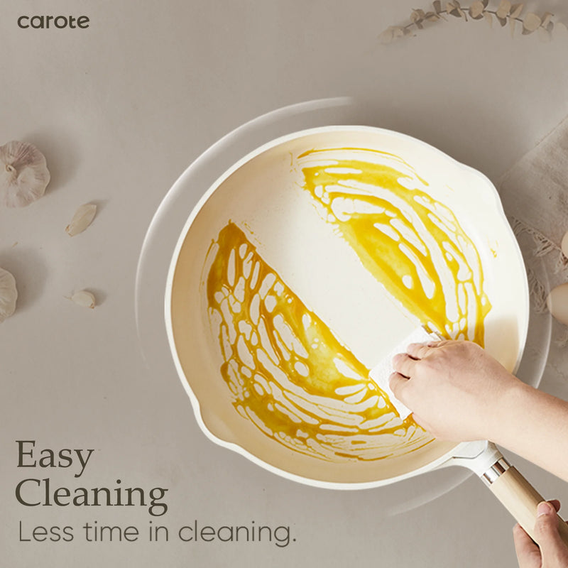 Person cleaning a pan with yellow residue using a scrubber, with 'carote' brand visible.