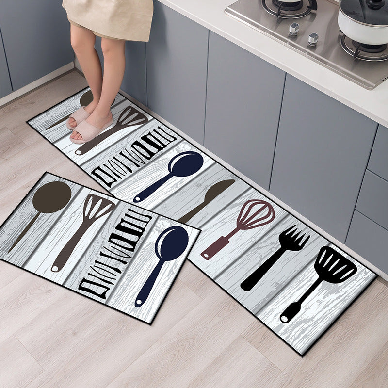 Set of kitchen-themed doormats with utensil designs on a wooden floor.