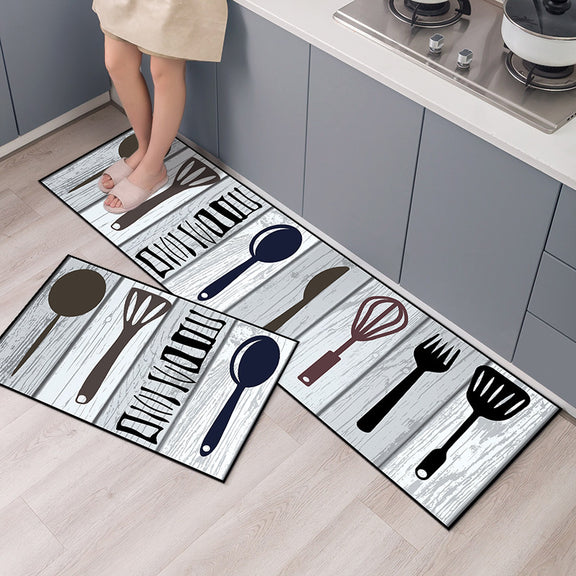Set of kitchen-themed doormats with utensil designs on a wooden floor.