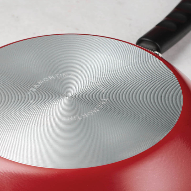 Red Frying pan face down displaying Tramontina brand