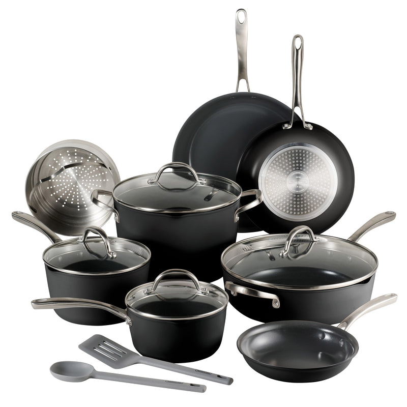 Set of black cookware with silver handles and glass lids on a white background