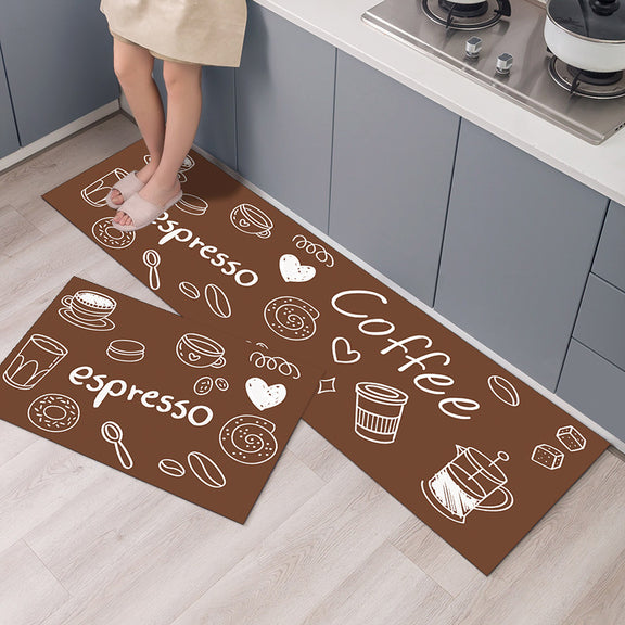 Brown kitchen mat with coffee-themed designs on a wooden floor.