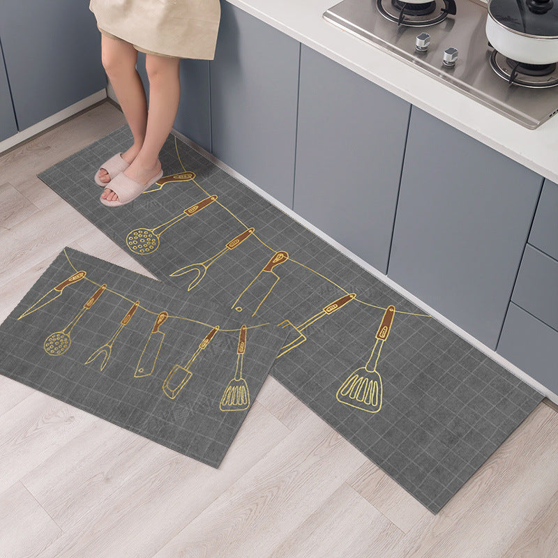 Gray kitchen mats with yellow utensil designs on a wooden floor.