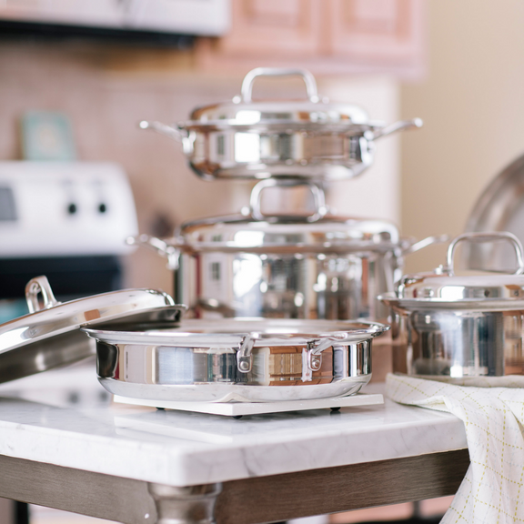 Set of stainless steel cookware on a kitchen counter