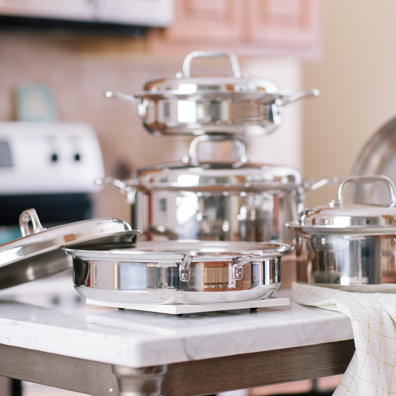 Set of stainless steel cookware on a kitchen counter