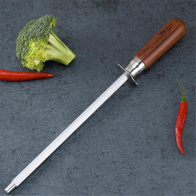 Knife Sharpener with wooden handle on a dark surface with vegetables