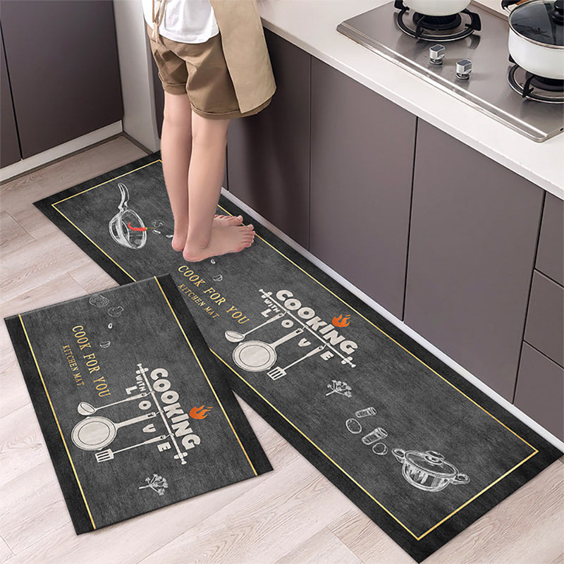 Two kitchen mats with cooking-themed designs on a wooden floor.