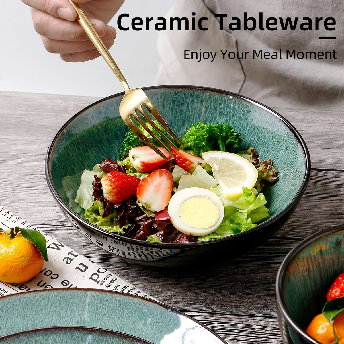 Ceramic tableware with a salad and a hand holding a fork, promoting 'Enjoy Your Meal Moment'.