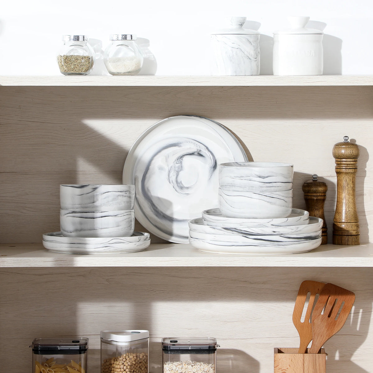 White ceramic dinnerware set on a wooden shelf with kitchen items.