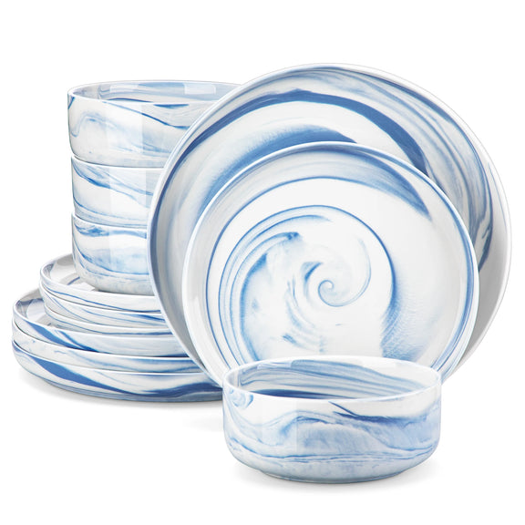 Set of blue and white marbled ceramic plates and bowls on a white background