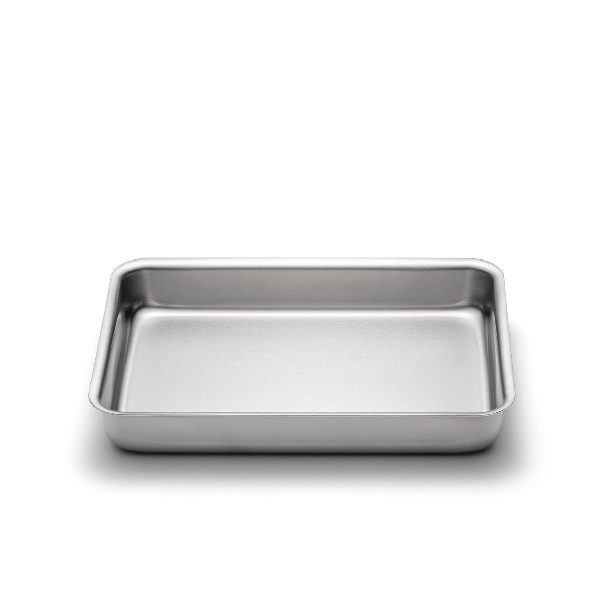 Stainless steel baking tray on a white background