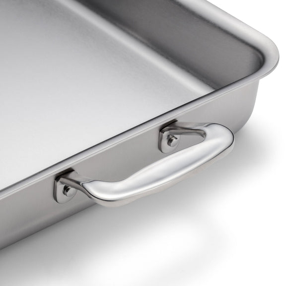 Stainless steel baking tray with handle on a white background