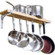 Set of stainless steel pots and pans hanging on a wooden rack against a white background