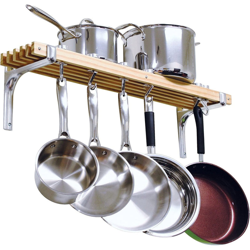 Set of stainless steel pots and pans hanging on a wooden rack against a white background