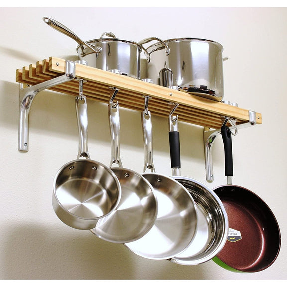 Wooden pot rack with stainless steel pots and pans on a white wall.