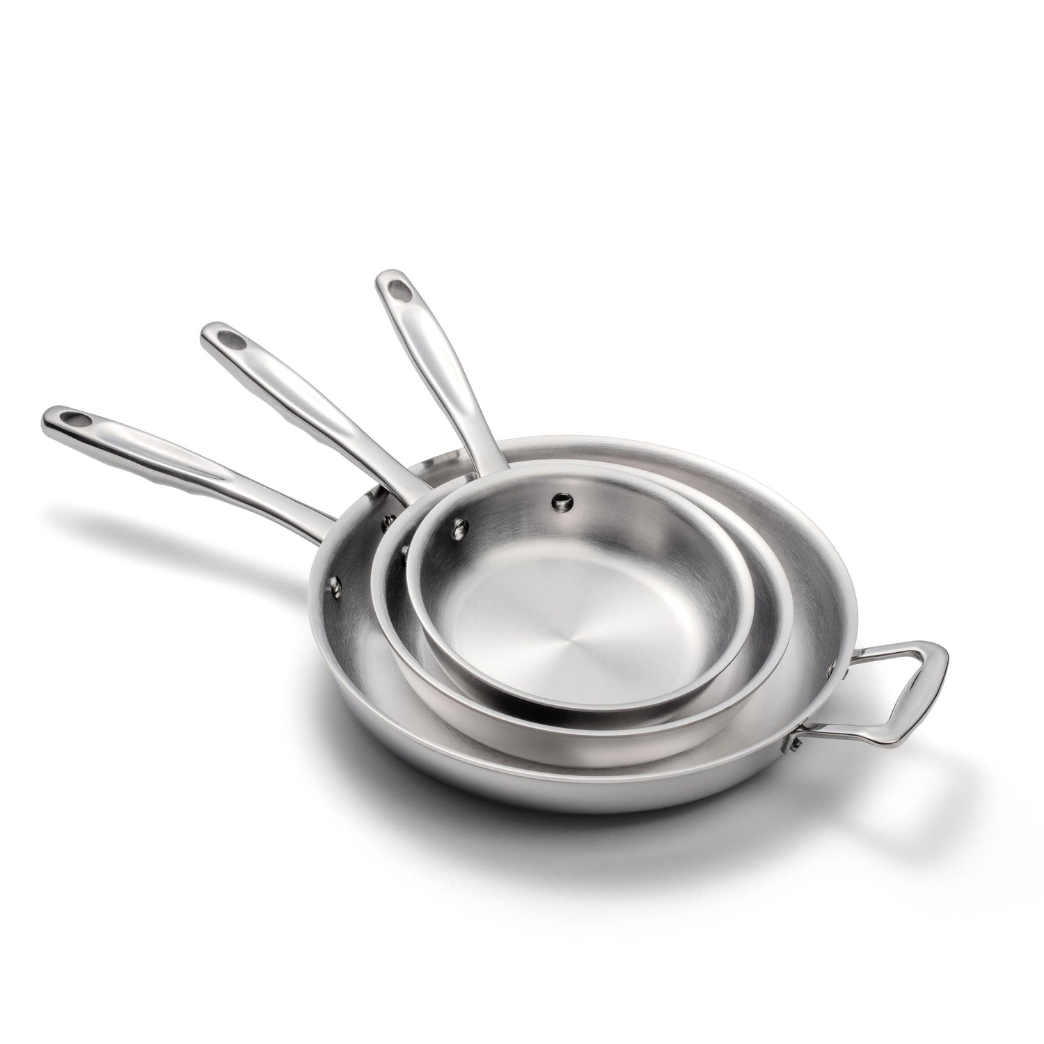 Set of three stainless steel cookware pieces on a white background